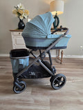 CYBEX eGazelle S with the carrycot mounted up top and the CYBEX shopping basket carried in the lower slot below it