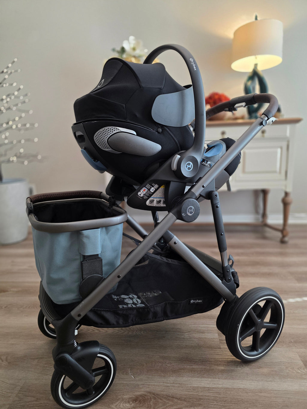 Infant car seat on the eGazelle S frame with the shopping basket mounted below it on the Stroller House brackets