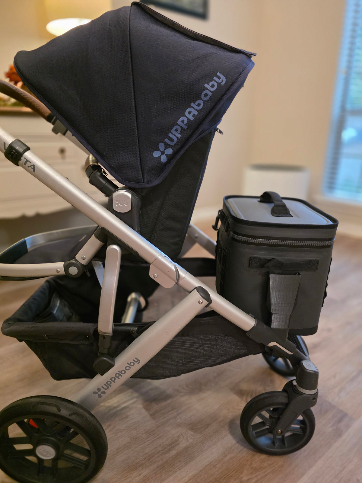 Side profile of an UPPAbaby Vista with the YETI Hopper Flip carried in the lower position and the toddler seat and canopy above it unaffected