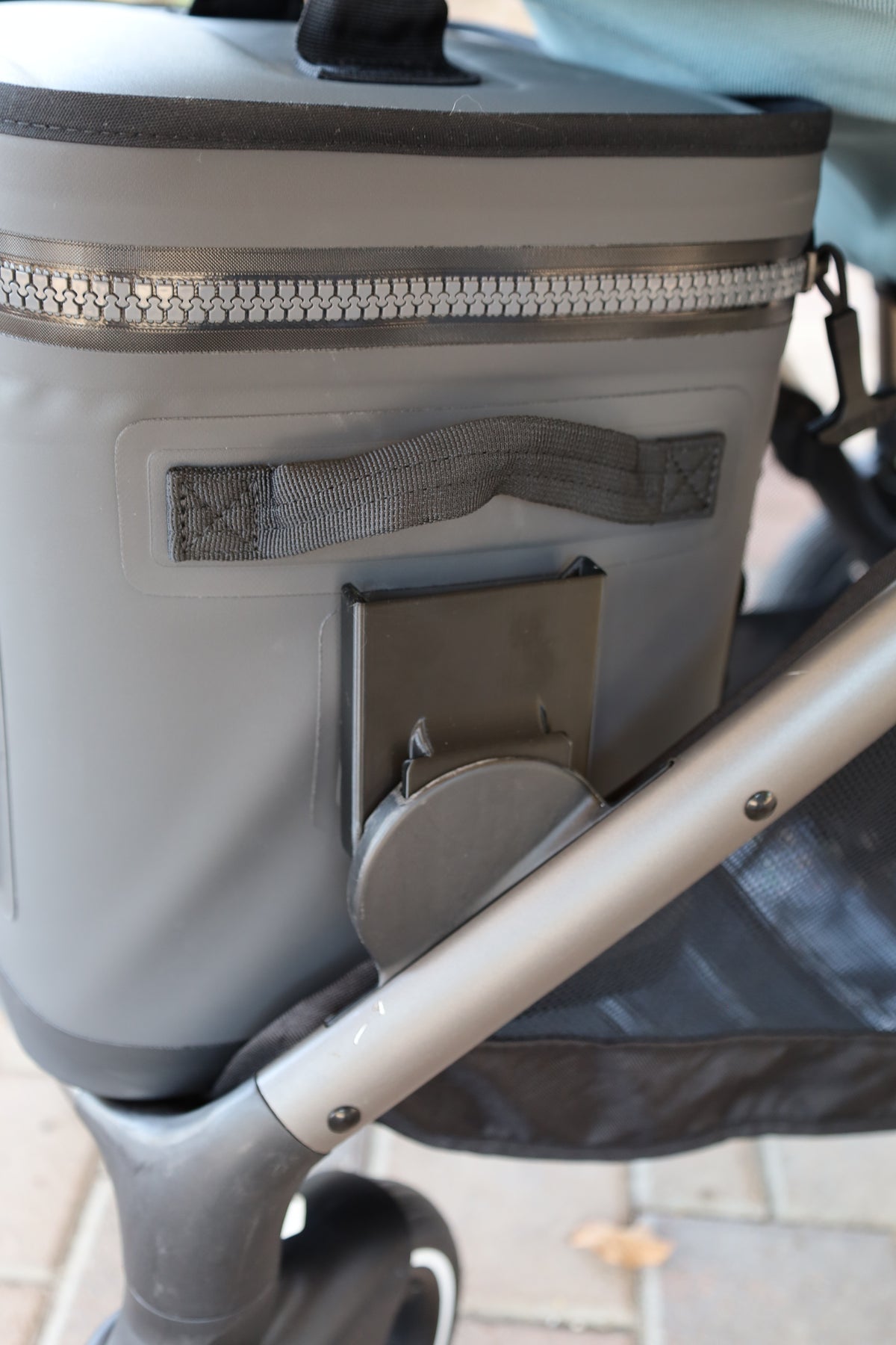 Close-up of the Stroller House cooler mount: the 3D printed bracket clips into the Gazelle S lower connection point and holds the Hopper Flip securely by its side