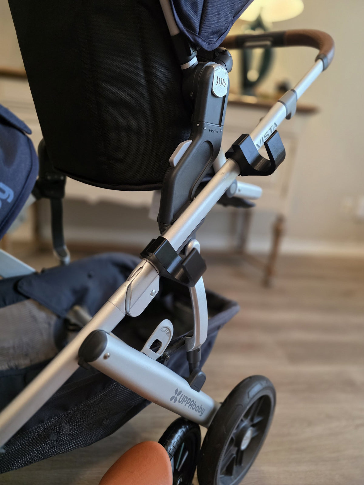 The matched pair of Stroller House holders mounted on the Vista frame tube, showing the spacing between them and the shape of the U-shaped cradle.